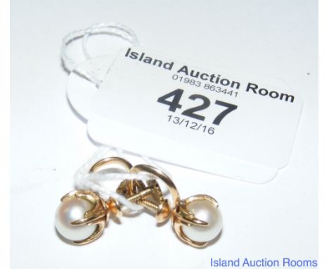 A pair of clip-on pearl earrings in gold setting