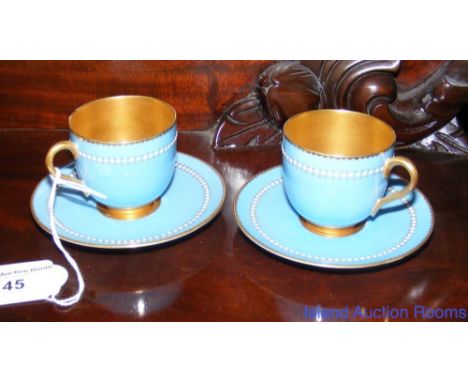 Pair of 19th century turquoise and gilt Royal Worcester coffee cans and saucers