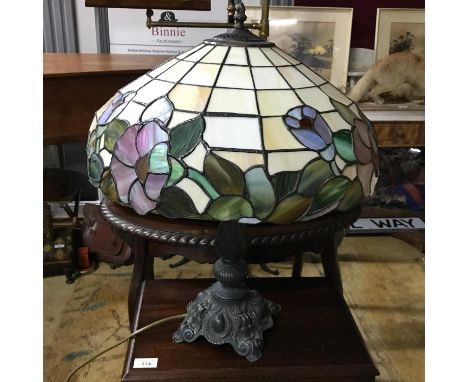 A Large Tiffany style table lamp, Detailed with an ornate metal base, Floral design stain glass shade. Iin a working conditio