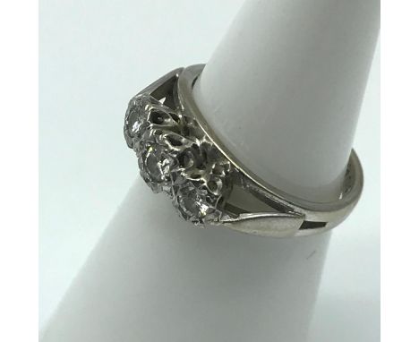 An 18ct white gold ladies ring set with 3 diamonds, Ring size J, Weighs 3.92grams 