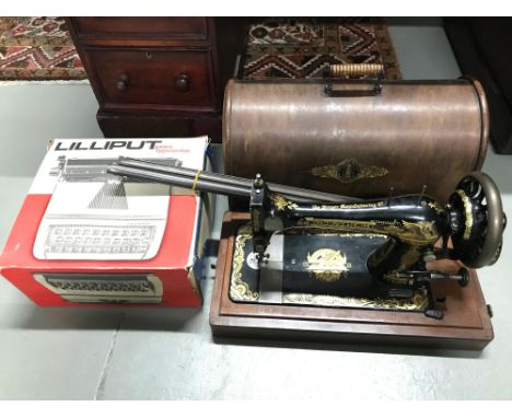 Antique singer sewing machine with carry case (Egyptian art work) together with Lilliput Junior Typewriter with original box 