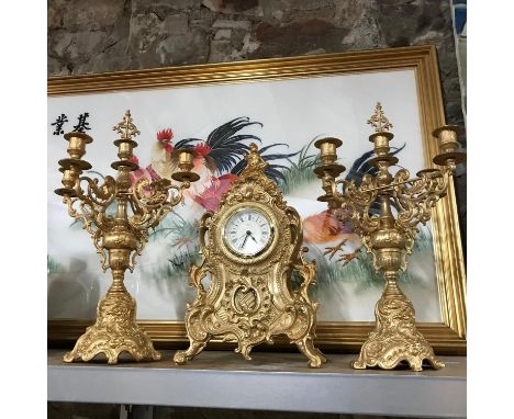 A Reproduction Gilt Brass ornate mantel clock with matching candelabras 