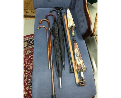 A selection of vintage walking sticks, umbrellas, parasols &amp; measuring stick 