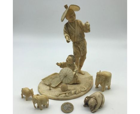 A Japanese Meiji period ivory hand carved figures of older gentleman and child, signature to the base, 3 hand carved animals 