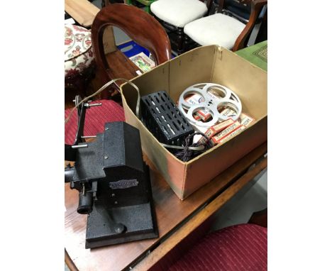 A Vintage Bingoscope projector, reels and films. 