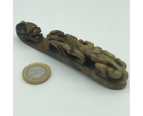 Antique Chinese hand carved hardstone/ jade belt hook. designed with a dragon head and body. Measures 12cm in length