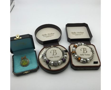 A Vintage Juicy Couture Crimes of Couture badge with original box. Together with two Bella Perlina charm style bracelets with