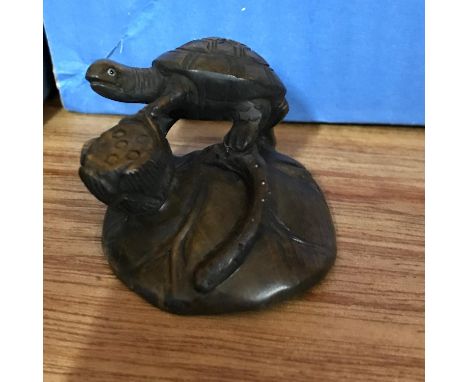 A Japanese hand carved netsuke of a Turtle hand singed by the artist. 