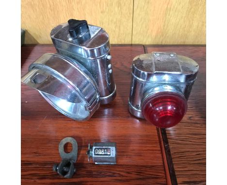 A Lot of two vintage bike lanterns together with bicycle odometer by Lucas. 