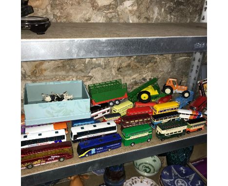 A Shelf of various bus models and Britains farm animals, Tractor and accessories 