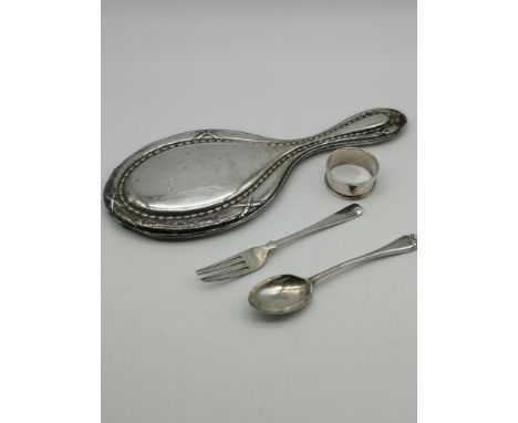 A Birmingham silver hand mirror, Birmingham silver napkin ring, Sheffield silver tea spoon &amp; London silver fork. 