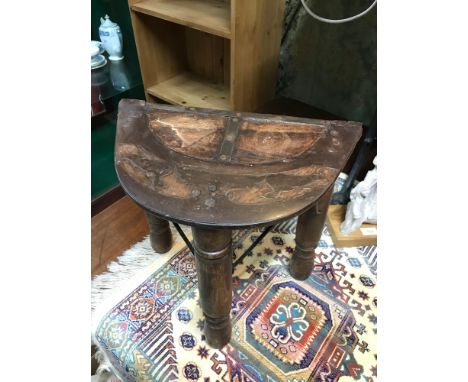 A Rustic antique style three leg support milking stool, designed with metal inlays over solid wood. Measures 37x39x23.5cm 