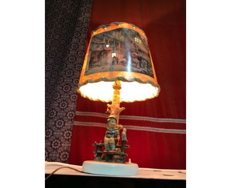 Goebel Hummel boy sitting on a fence post table lamp. In a working condition. 