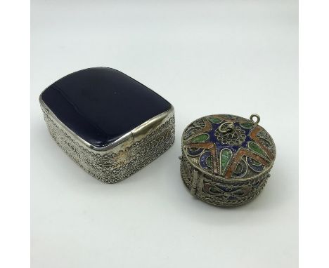 A Lot of two white metal trinket boxes. One is made with white metal and enamel which the trinket box Splits into three parts