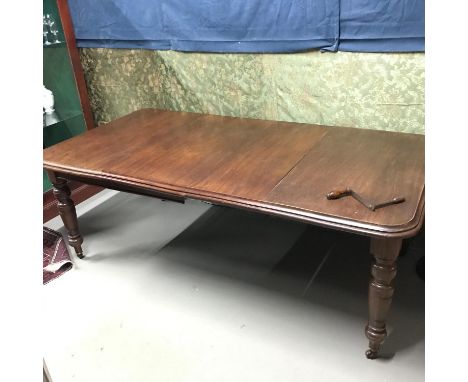 A Victorian Mahogany wind out table comes with two leafs, turned leg supports on original ceramic castors. Measures 75x210x11