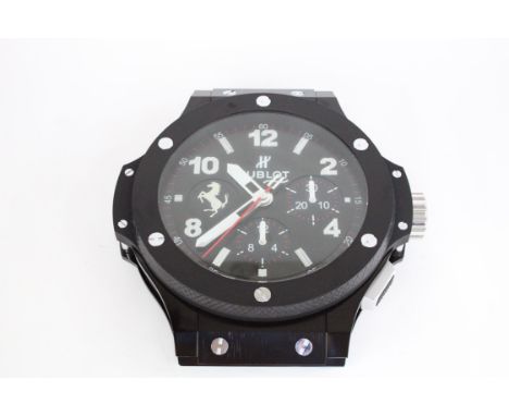 An extremely rare Hublot Big Bang Ferrari dealership wall clock, in perfect condition complete with the original flight case.