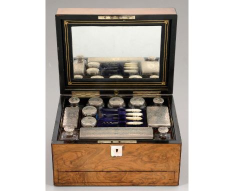 A VICTORIAN SILVER FITTED WALNUT DRESSING CASE&nbsp; the cut glass accessories with silver cap or cover,&nbsp; each engraved 