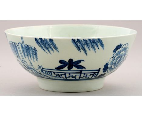 A LIVERPOOL BLUE AND WHITE SLOP BASIN, RICHARD CHAFFERS &amp; CO, C1760-65 painted with a peony, willow tree and fence, 15.5c