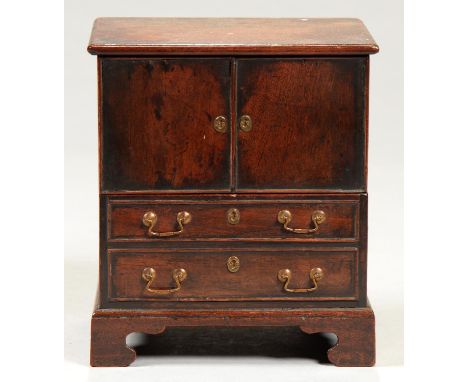 MINIATURE FURNITURE.&nbsp; A MAHOGANY COMMODE&nbsp; of chest form with lifting, hinged front and two blind drawers, 19cm h Go