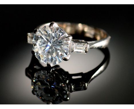 A&nbsp;DIAMOND&nbsp; RING&nbsp;&nbsp; the round brilliant cut diamond of approx 3.2cts flanked by a baguette diamond to each 