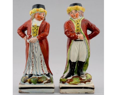 A PAIR OF STAFFORDSHIRE PEARL GLAZED EARTHENWARE FIGURES OF A MAN AND WOMAN IN TURKISH COSTUME, C1830 on square base with bla
