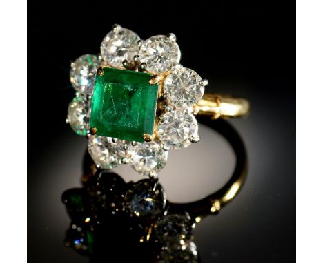 AN EMERALD AND DIAMOND RING,&nbsp; with step cut emerald of approx 6 x 6mm and of approx 2ct, in a surround of eight evenly s