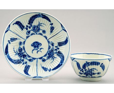 A WORCESTER BLUE AND WHITE RIBBED TEA BOWL AND SAUCER, C1770-90 painted with the Immortelle pattern, 12cm diam, open crescent