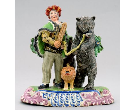 A STAFFORDSHIRE PEARL GLAZED EARTHENWARE BEAR GROUP, C1830&nbsp; in the form of a man in oriental costume with a stick beside