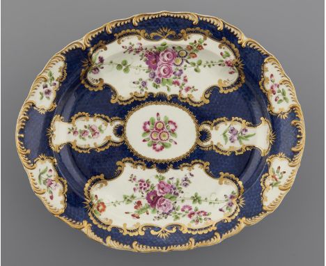 A WORCESTER SCALE BLUE GROUND OVAL DISH, C1770&nbsp;painted in brilliant enamels with floral reserves on a well defined groun