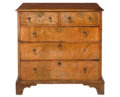 A WALNUT AND FEATHERBANDED CHEST OF DRAWERS,with quarter veneered top and brass drop handles, on bracket feet, 101cm h; 57 x 