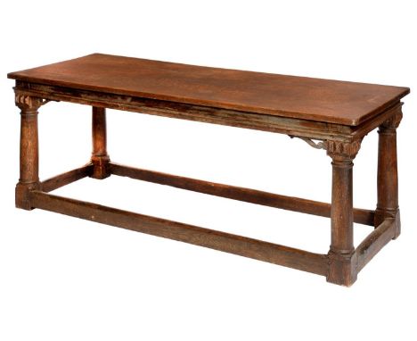 A JAMES I STYLE OAK REFECTORY TABLE&nbsp; the single plank top on four architectural columnar legs united by stretchers, 78cm