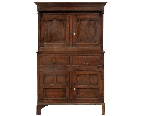 AN OAK&nbsp; PRESS CUPBOARD, 18TH C&nbsp; the canopied upper part with turned pendants,&nbsp; enclosed by twin ogee arch pane
