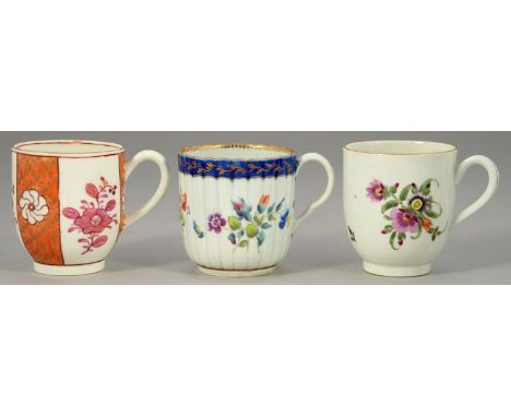 THREE WORCESTER POLYCHROME COFFEE CUPS, C1770-80&nbsp; two painted with flowers one beneath a blue border,&nbsp; the other wi