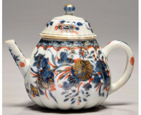 A CHINESE IMARI LOBED TEAPOT AND A COVER, EARLY 18TH C&nbsp; painted with flowers, 10.5cm h Chip under cover not visible when