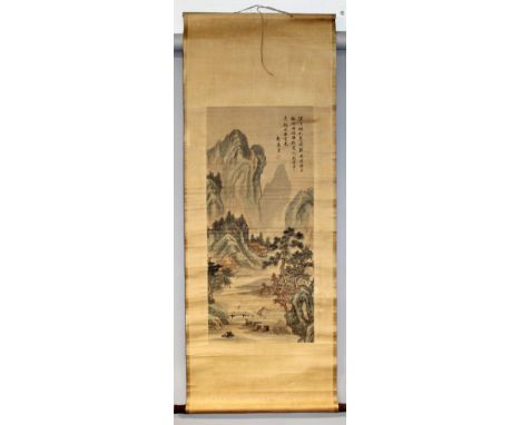 A CHINESE HANGING SCROLL PICTURE ON PAPER, decorated with columns of calligraphy and a mountainous landscape setting, the pic