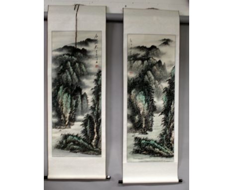 A PAIR OF CHINESE HANGING SCROLL PAINTINGS ON PAPER, within patterned silk surrounds, each depicting a mountainous landscape 
