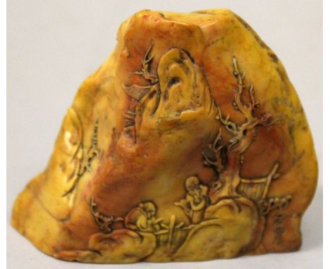 A CHINESE SOAPSTONE BOULDER SEAL, modelled in the form of diminutive sages in a mountainous setting, the side signed Shi Nong