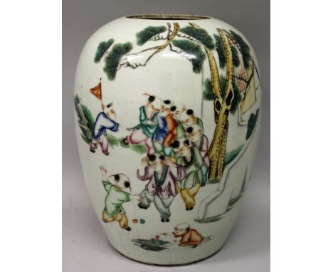 AN EARLY 20TH CENTURY CHINESE FAMILLE ROSE PORCELAIN JAR, painted with calligraphy and a scene of playing boys, 10.75in high.