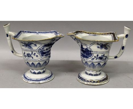 A PAIR OF 18TH CENTURY CHINESE EXPORT QIANLONG PERIOD BLUE & WHITE PORCELAIN HELMET JUGS, with moulded rib-bordered panels of