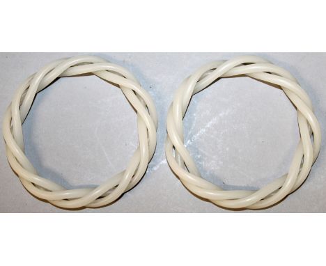 A PAIR OF CHINESE WHITE JADE-LIKE TRIPLE TWIST BANGLES, 3.1in diameter.