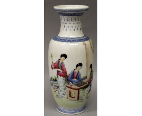 A 20TH CENTURY CHINESE FAMILLE ROSE PORCELAIN VASE, painted with a garden scene of ladies playing Go, the base with a Qianlon