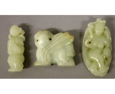 A CHINESE PALE CELADON JADE-LIKE MODEL OF A WINGED PIXIU, 1.8in wide x 1.6in high; together with two further celadon jade-lik