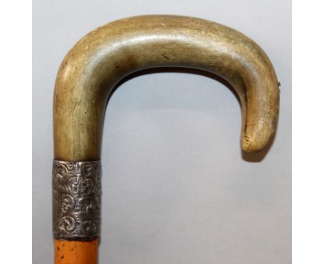 ANOTHER 19TH CENTURY RHINOCEROS HORN HANDLED WOOD WALKING STICK, with a silver-metal collar inscribed 'J OLGILVIE', the curve