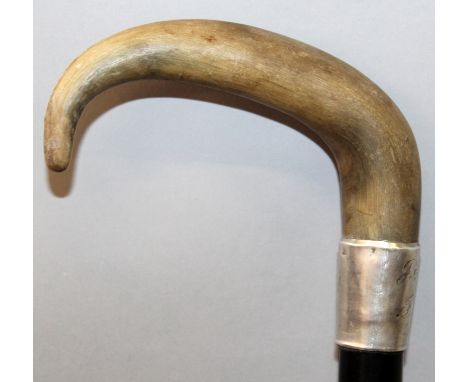 A 19TH CENTURY RHINOCEROS HORN HANDLED WOOD WALKING STICK, with a hallmarked silver collar inscribed with two monograms and a