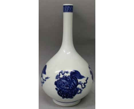 A CHINESE BLUE & WHITE PORCELAIN BOTTLE VASE, decorated with buddhistic lions playing with ribboned and brocaded balls, the b