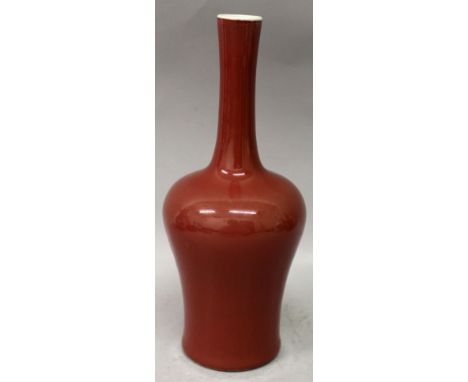 A CHINESE SANG-DE-BOEUF PORCELAIN VASE, applied with an even glaze, the base with a four-character Kangxi mark, 9.75in high.