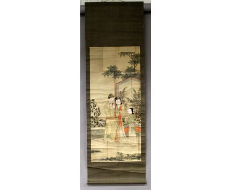 A 19TH CENTURY CHINESE HANGING SCROLL PAINTING ON PAPER, painted with a fenced garden scene of a couple and girl attendant st