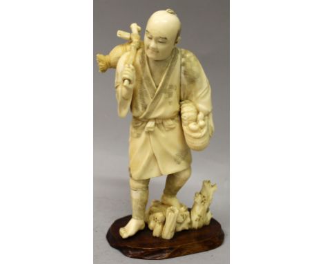 A JAPANESE MEIJI PERIOD IVORY OKIMONO OF A STANDING FARMER, one foot resting on rockwork, a basket of fruit in one hand, his 