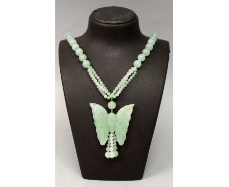 A CHINESE CELADON GREEN JADE-LIKE NECKLACE, with a butterfly pendant.