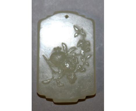 A SMALL CHINESE SHAPED JADE PENDANT, decorated in relief to one side with a spray of pomegranate, 1.3in x 0.8in.